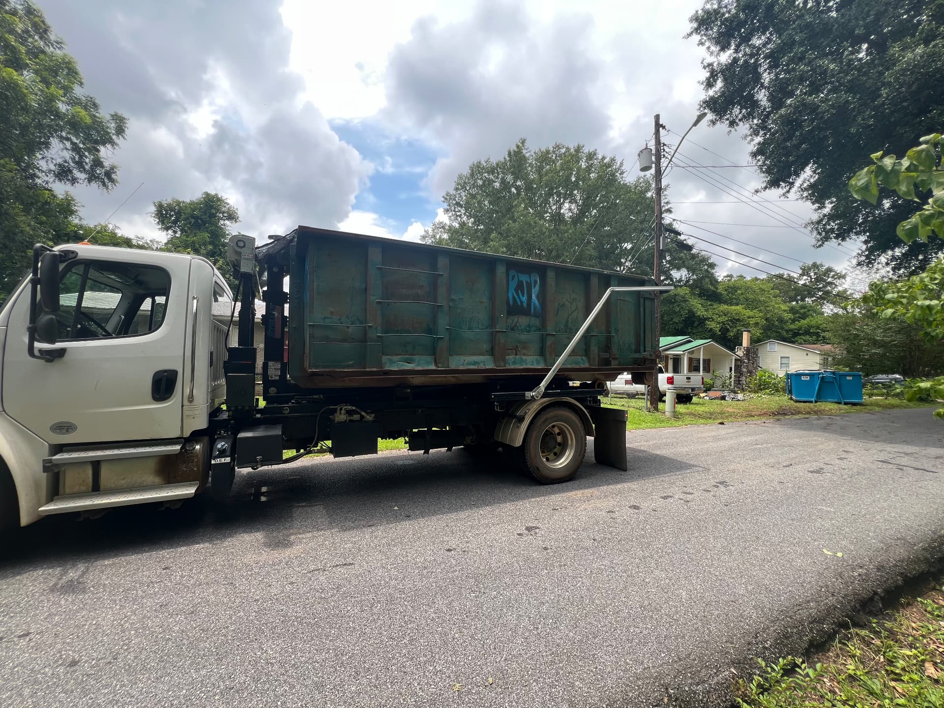 Roll off dumpster pickup on a residential street in Alexandria, Alabama