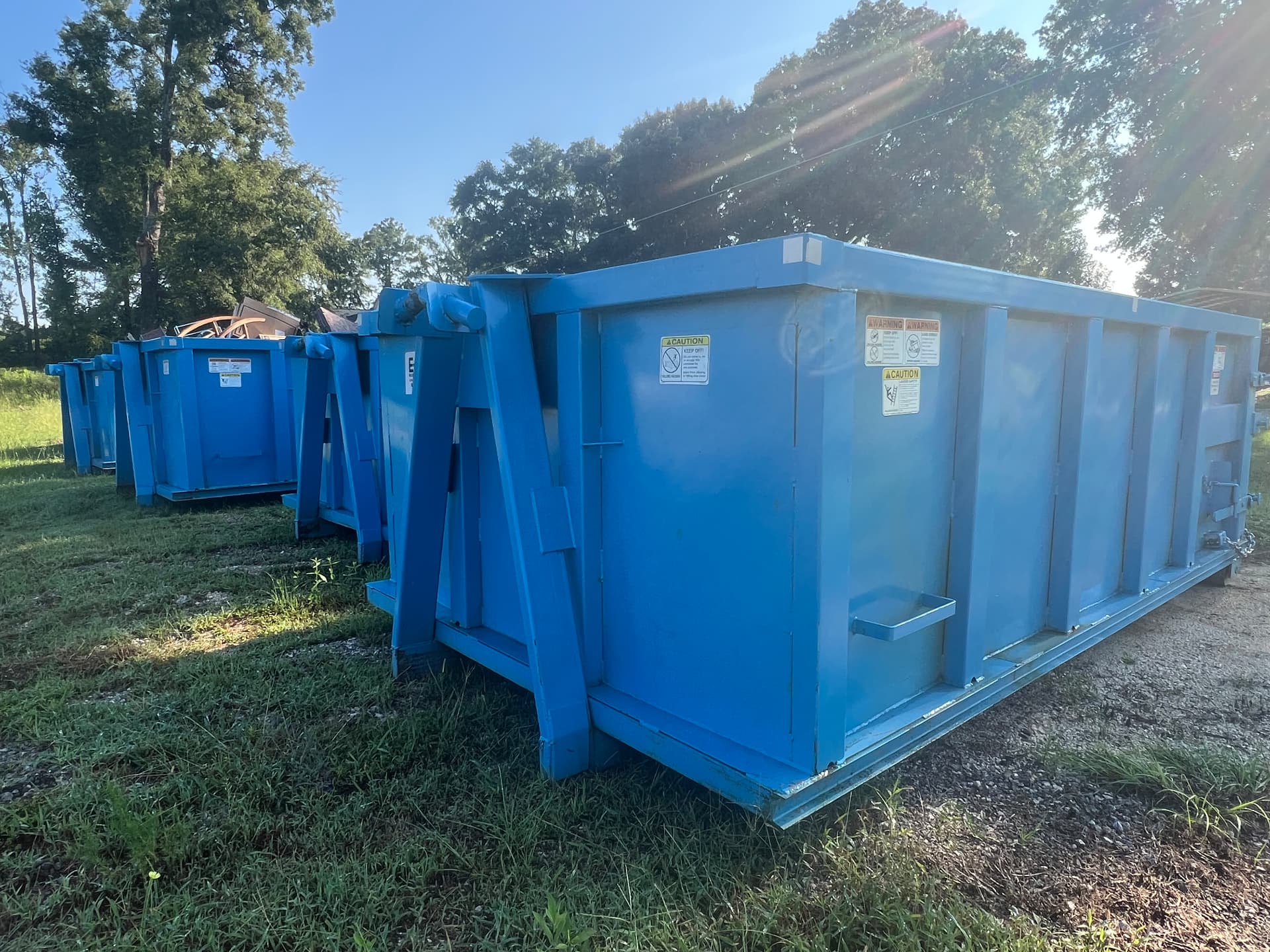 Blue Riba Roll-Off Co. roll-off dumpsters lined up at the yard in Alexandria, Alabama